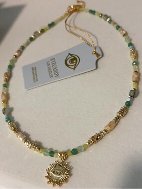 Eye Candy Gold Sun Eye Pendant Necklace with Green and Cream Beads